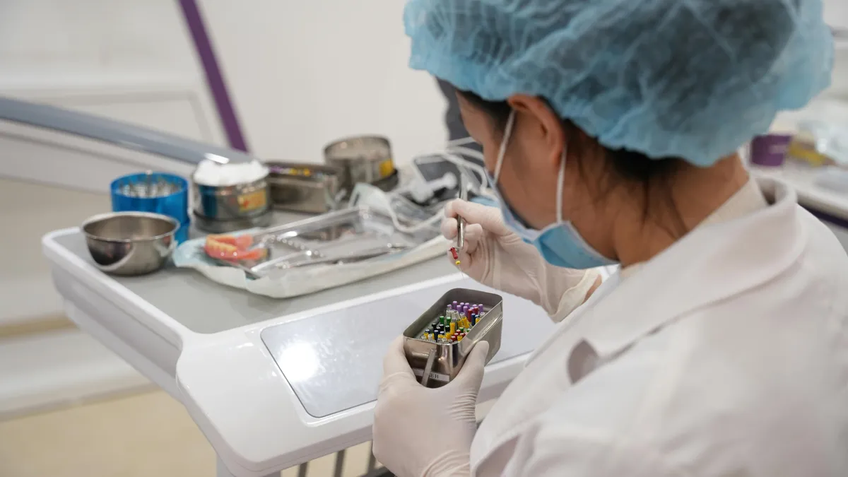 Dental professional preparing instrument tray for family dental appointment in Prosper TX
