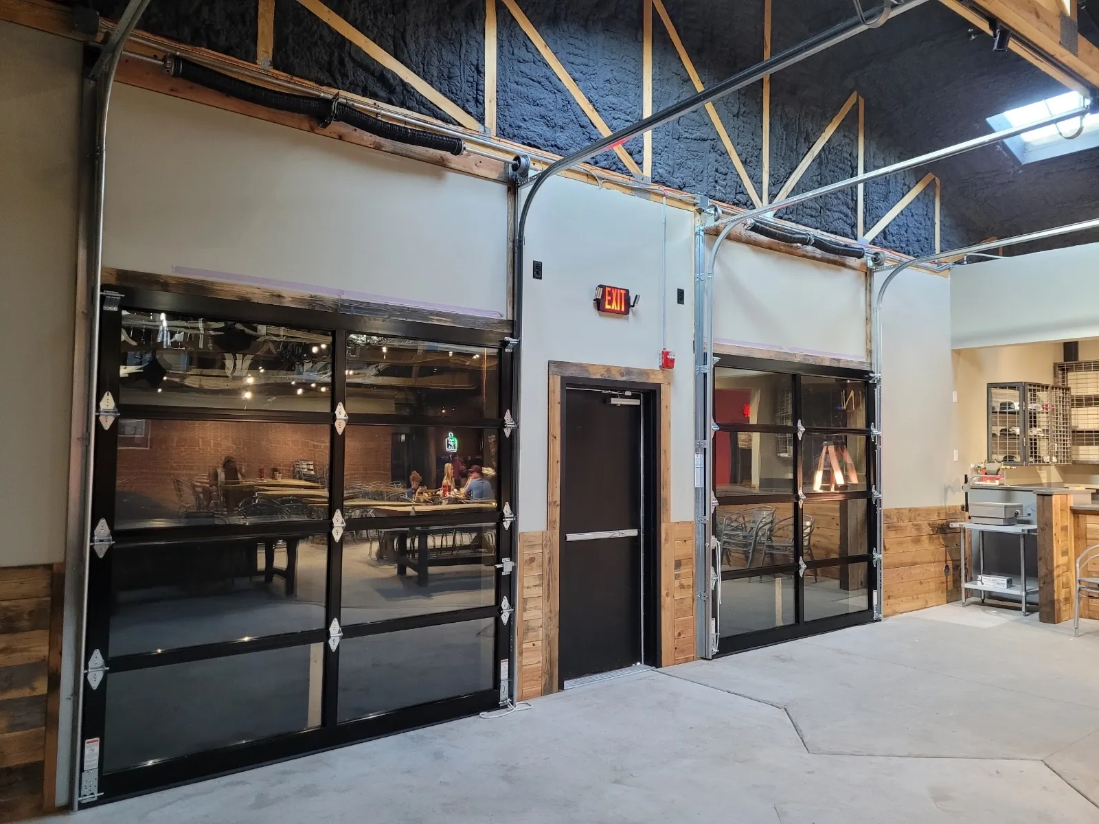 Commercial glass garage doors installed by Close Automatic Garage Door at The Gin in Prosper, TX